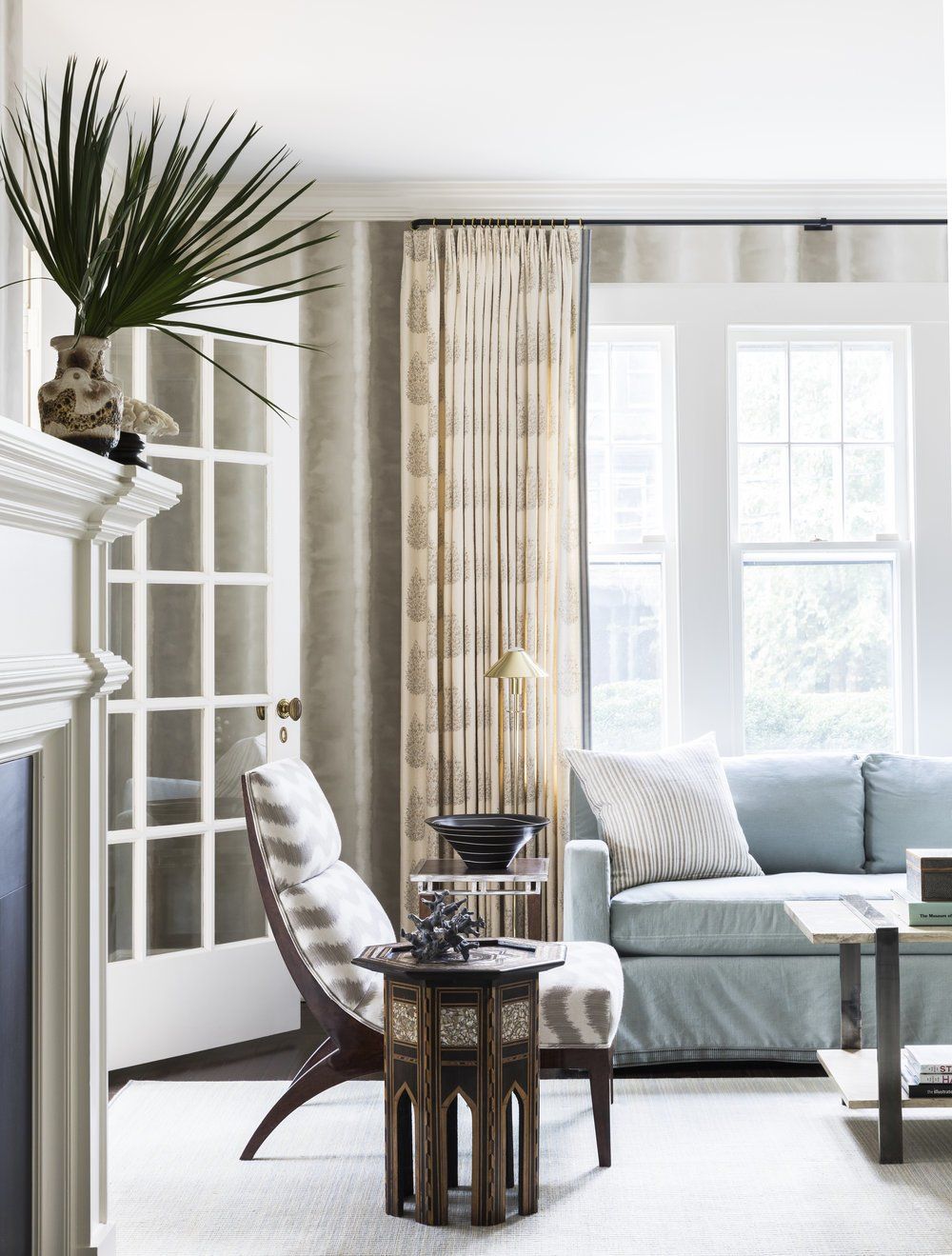 ideal curtains, Kevin Isbell, selected pinch pleated block-print linen curtains with tape-trim on the leading and bottom edges hung from blackened metal rods and brass rings for this calm clean living style.
